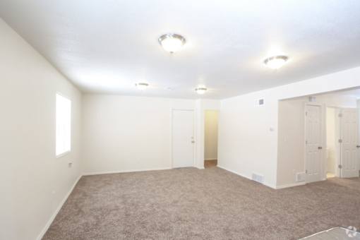 A room with carpeted floor and white walls.