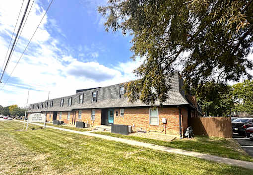 A row of houses with a grassy front yard.