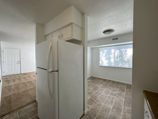 a kitchen with a refrigerator and a window