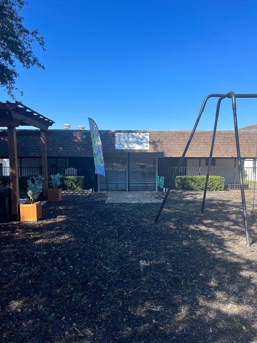 a swing set in front of a school building