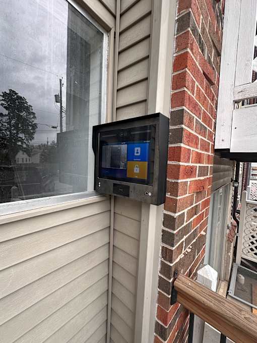 A brick wall with a black box on it.