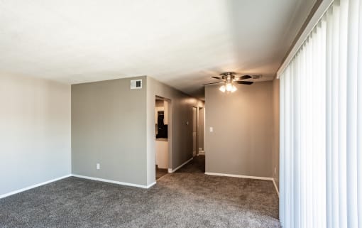Spacious living room looking into kitchen and down the hallway