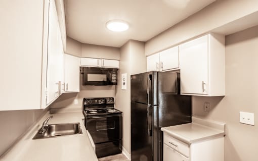 Kitchen with spacious cabinetry and black appliances