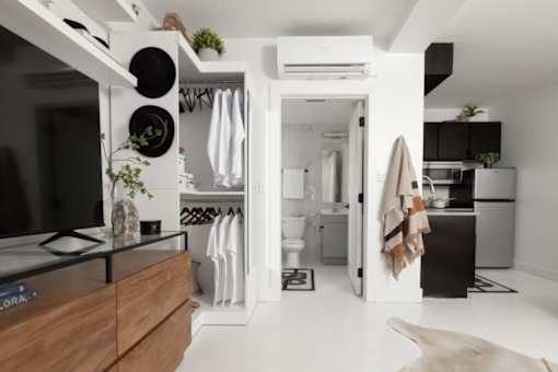 A modern kitchen with a wooden countertop and a black stove top.