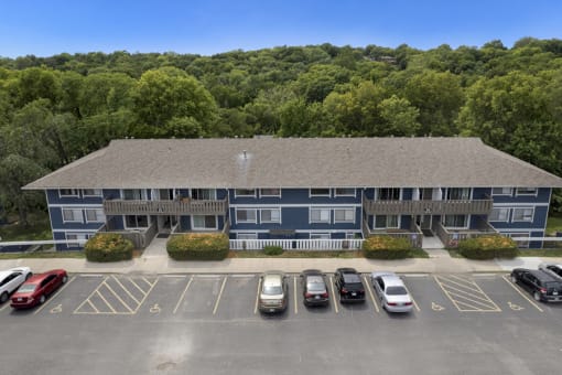 an aerial view of an apartment building with a parking lot