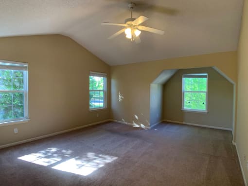Photo of master bedroom with vaulted ceiling and fan