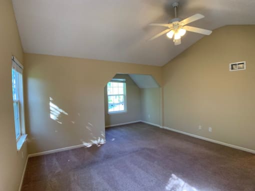 Photo of master bedroom with vaulted ceiling and fan