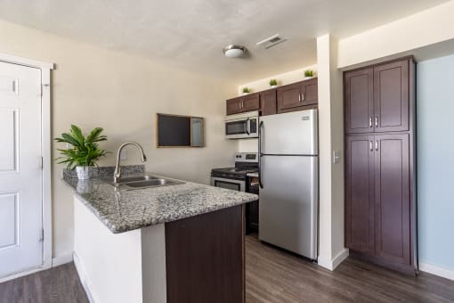 Kitchen with appliances and fridge at Bennett Ridge Apartments, Oklahoma City, Oklahoma