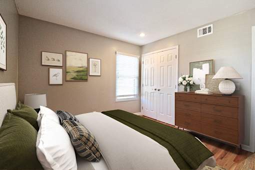 A bedroom with a bed, dresser, and pictures on the wall.
