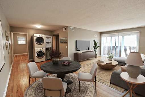 A living room with a round table and chairs.