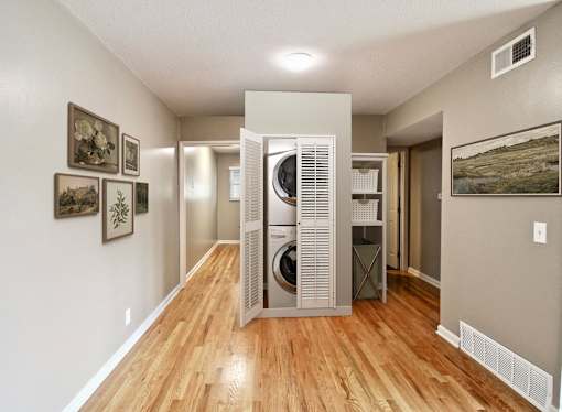 A hallway with a washer and dryer in it.