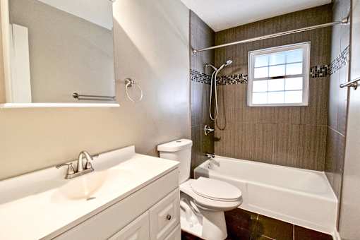 A white sink and toilet in a bathroom.