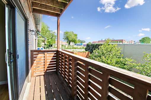 A wooden deck with a view of the sky and buildings.