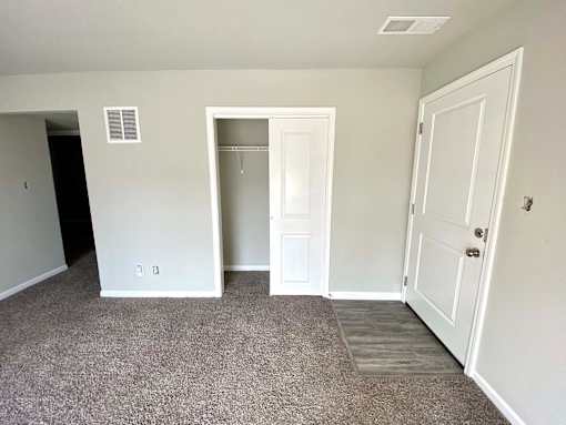 A room with a white door and a window.