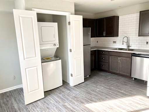 A kitchen with a white dishwasher and a white refrigerator.