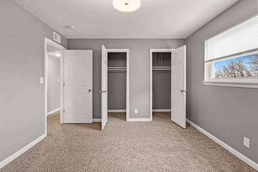 A room with three doors and a window.