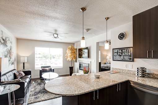 A modern kitchen and living room with a large island in the center.