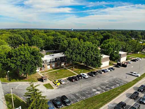 A parking lot with cars and a building in the background.