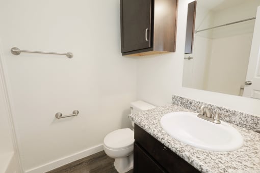 a bathroom with a sink toilet and mirror at Bennett Ridge Apartments, Oklahoma City, OK