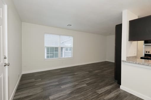 a bedroom with a large window and hardwood floors at Bennett Ridge Apartments, Oklahoma City, OK