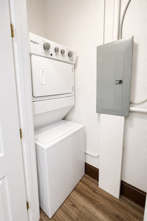 A white oven and dryer are installed in a small room.