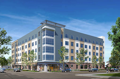 A modern multi-story building with a mix of beige and blue panels.