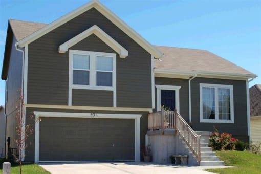 a brown house with a garage door