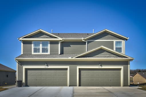 a house with a garage door in front of it