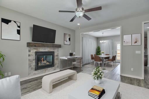 a living room with a fireplace and a table with chairs