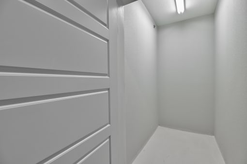 an empty room with a white wall and a white door