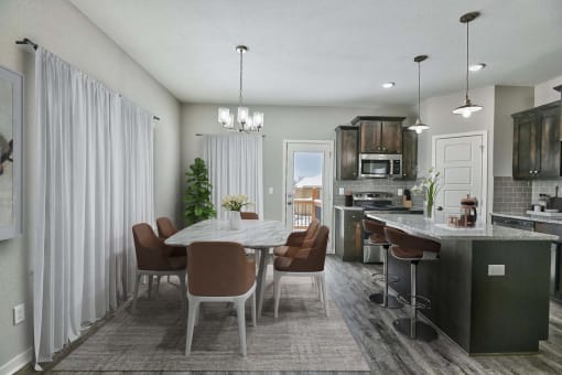 a kitchen and dining room with a table and chairs