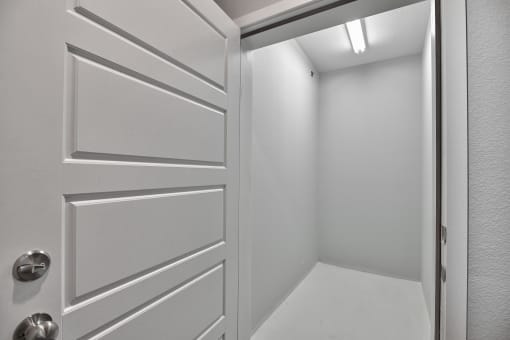 a white hallway with a white door and a white floor