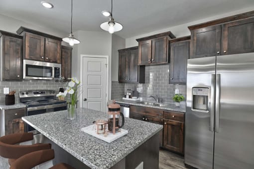 a kitchen with stainless steel appliances and granite counter tops