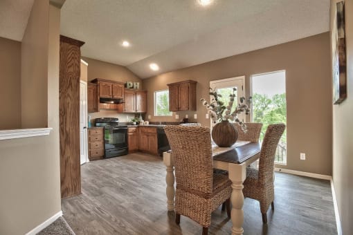 a kitchen and dining room with a table and chairs