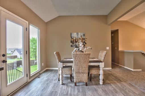 a dining room with a table and chairs and a sliding glass door