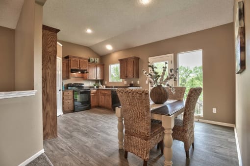 a kitchen and dining room with a table and chairs