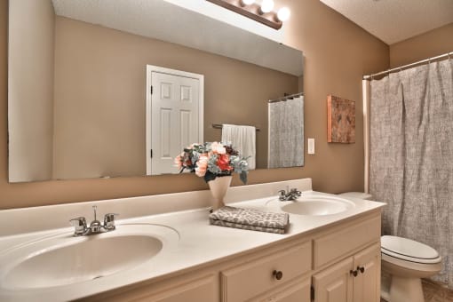 a bathroom with two sinks and a mirror