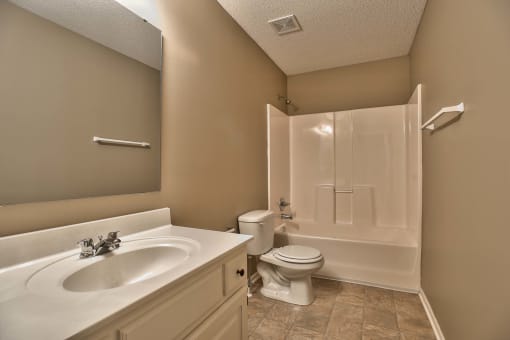 a bathroom with a sink toilet and a shower