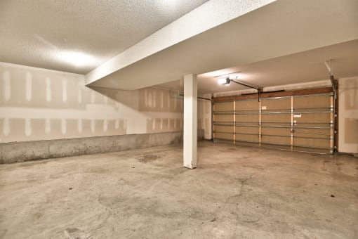 the interior of a garage in a house with a closed garage door