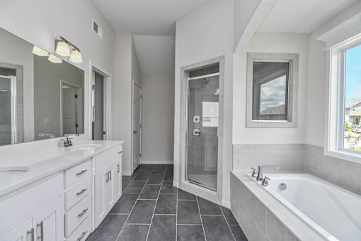 A bathroom with a white tub and sink.