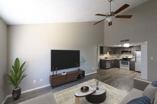 a living room with a flat screen tv and a kitchen