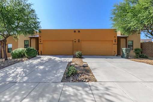 A house with a brown garage door and a driveway.