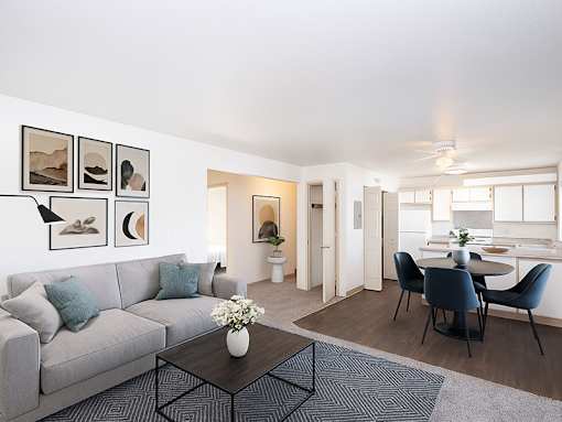 A living room with a grey couch, a coffee table, and a dining table with chairs.