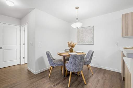 A dining room with a table and chairs.