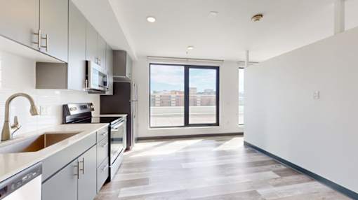 A modern kitchen with a view of the city through the window.