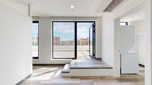 A modern room with a view of the city through the windows.