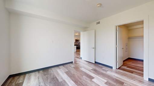 A room with a white wall and a wooden floor.