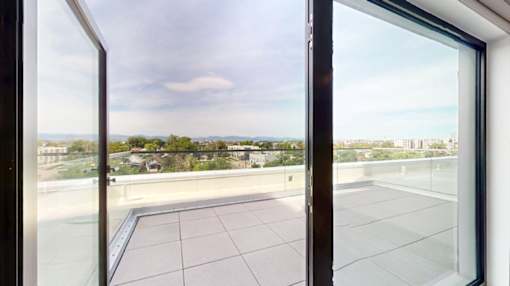 A view from a window looking out at a cityscape.