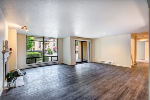 12 Central Square Open Living Room with wood floorings and windows and Patio doors