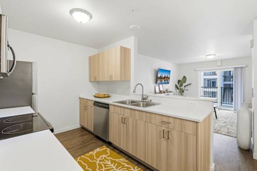 A modern kitchen with wooden cabinets and a white countertop.